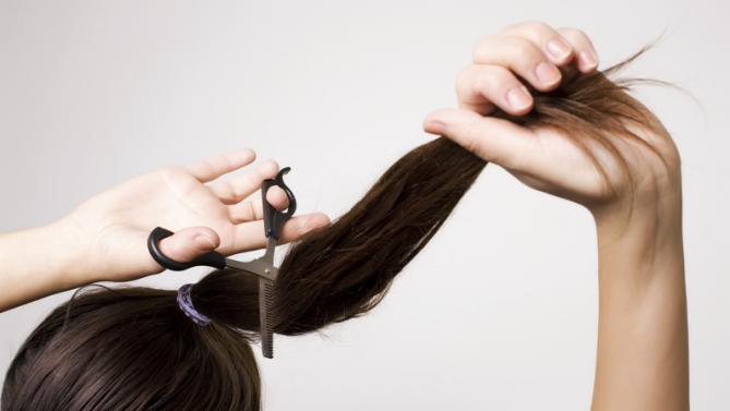 Woman cutting her ponytail