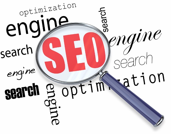 A magnifying glass hovering over several words - search, engine, optimization, focusing on acronym SEO