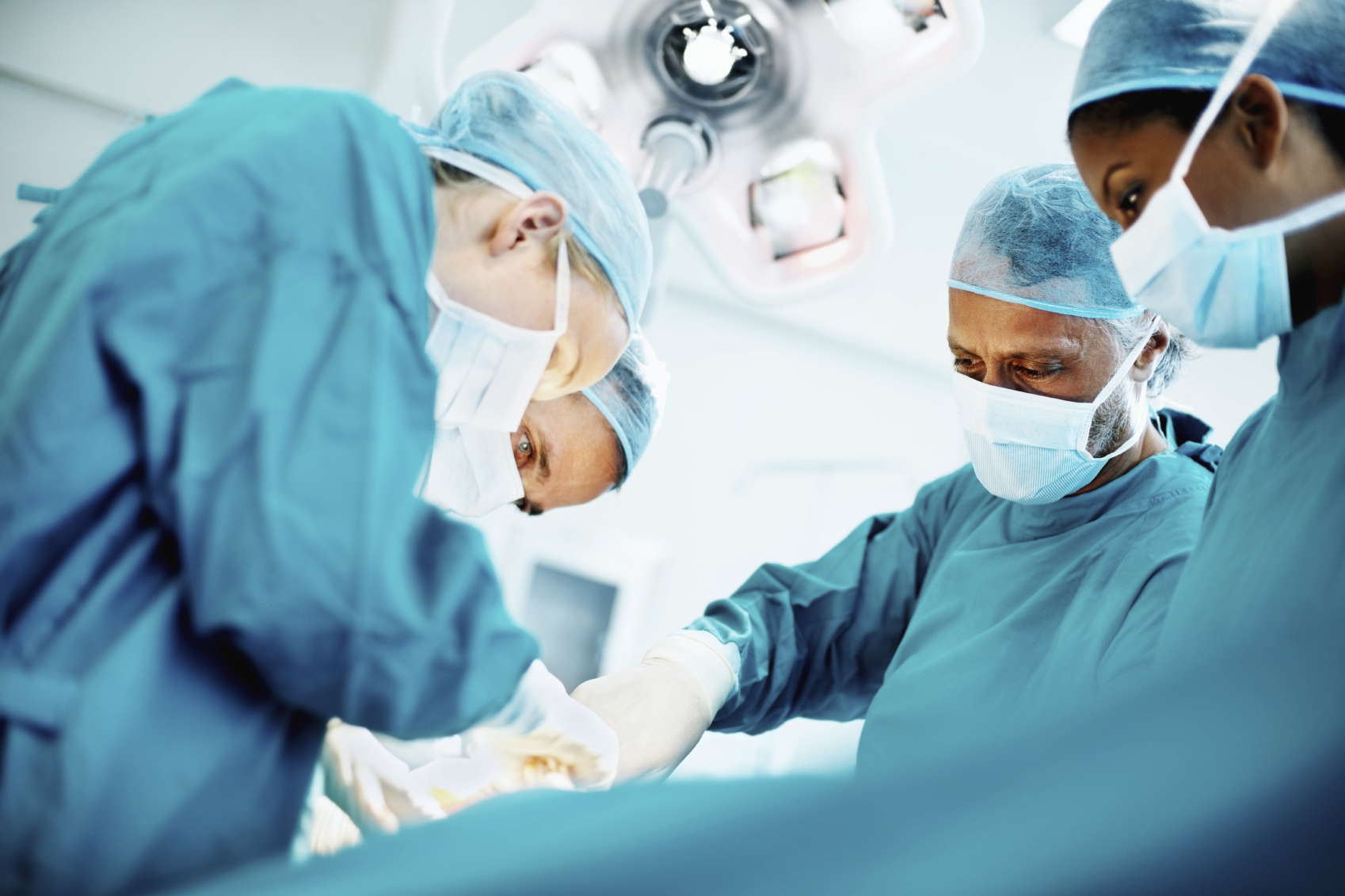 Low angle view of medical team in the operating theater performing surgery